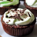 Front view of mini grasshopper pies with a chocolate cookie crust and mint cream filling, topped with a drizzle of dark chocolate, served in glass ramekins on a sleek modern surface with soft natural lighting